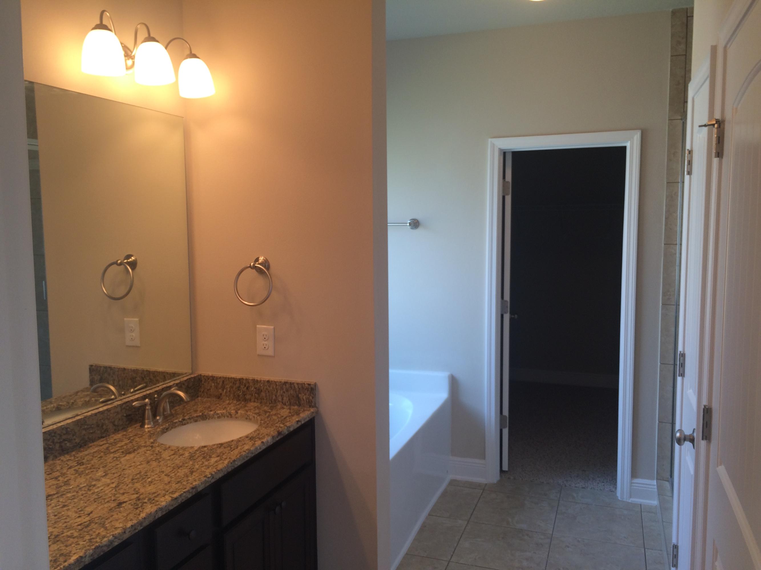389 Pin Oak Loop Santa Rosa Beach, FL 32459 - Photo 13 of 19 a bathroom with a granite countertop sink and a mirror