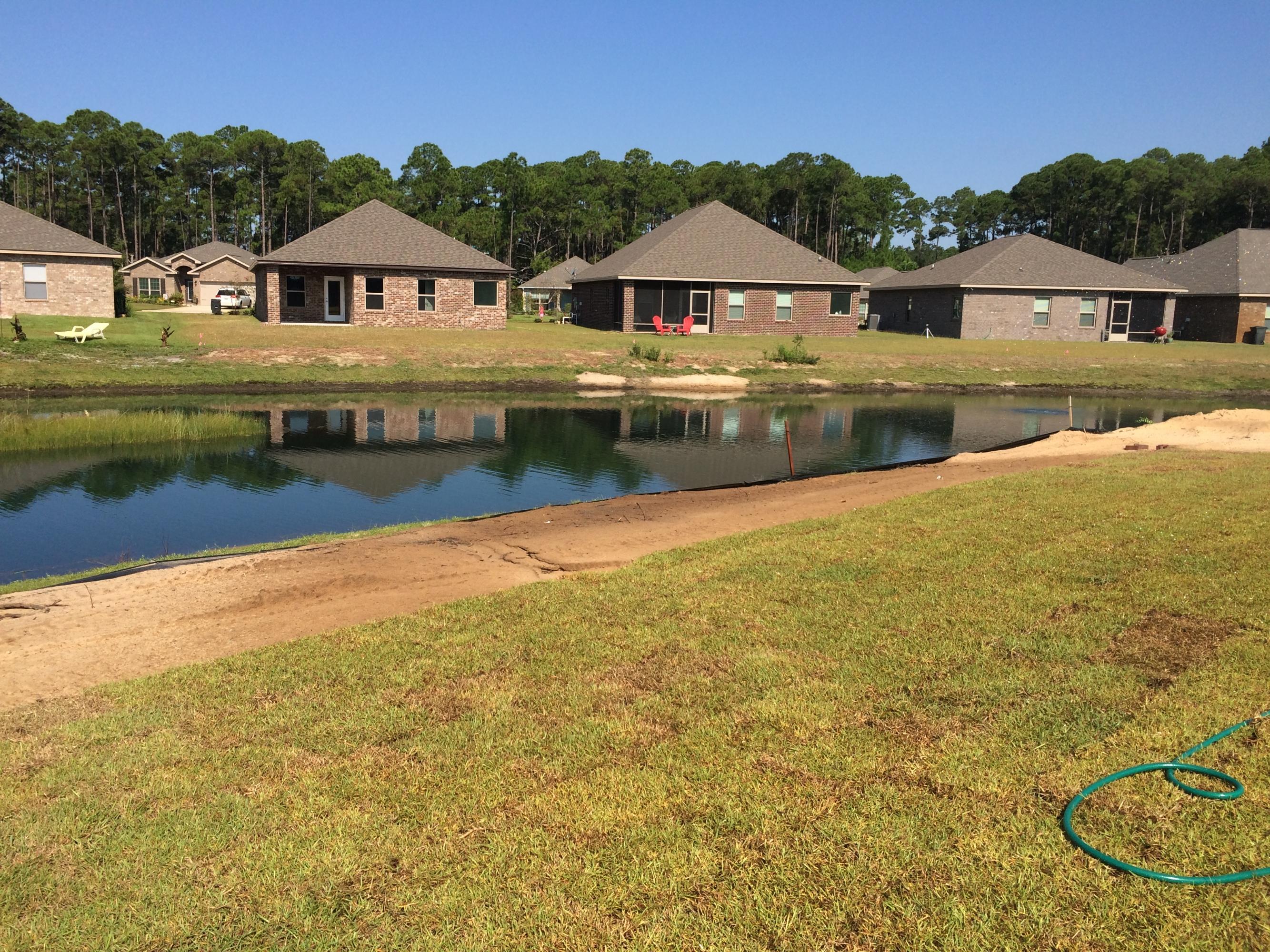 389 Pin Oak Loop Santa Rosa Beach, FL 32459 - Photo 16 of 19 a view of a house with yard and lake view