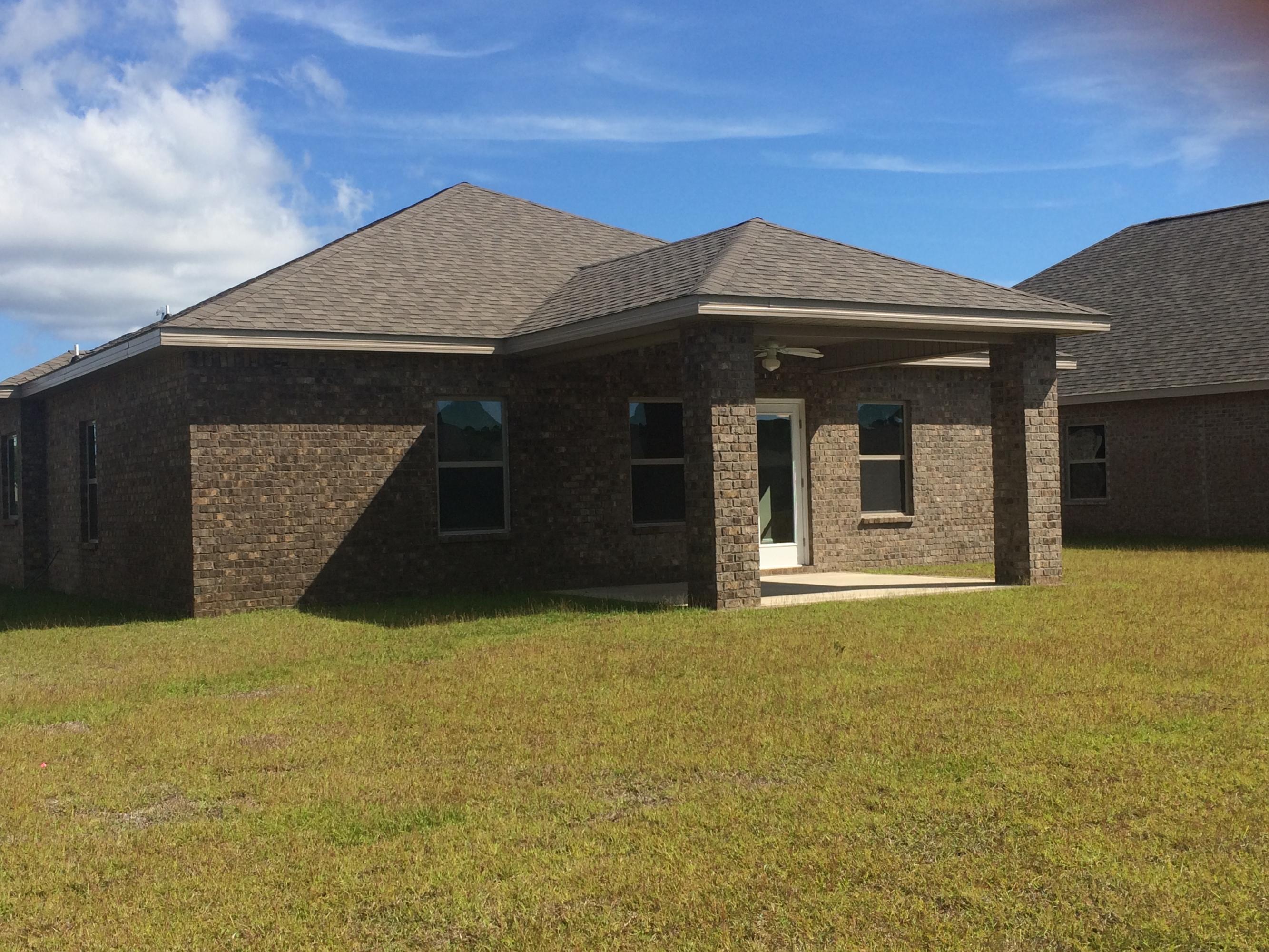 389 Pin Oak Loop Santa Rosa Beach, FL 32459 - Photo 17 of 19 a front view of a house with a yard