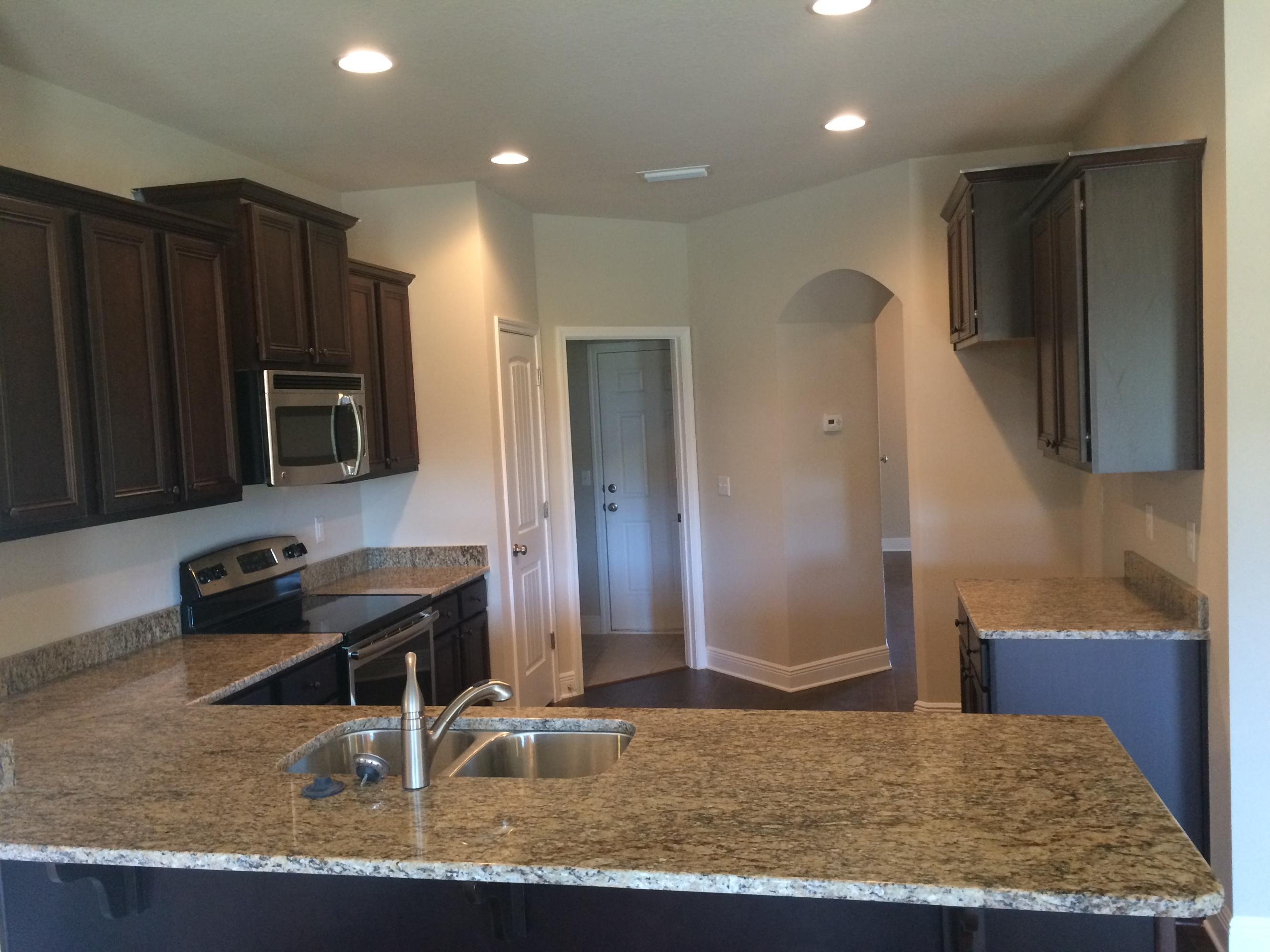 389 Pin Oak Loop Santa Rosa Beach, FL 32459 - Photo 10 of 19 a kitchen with stainless steel appliances granite countertop a refrigerator and a stove top oven