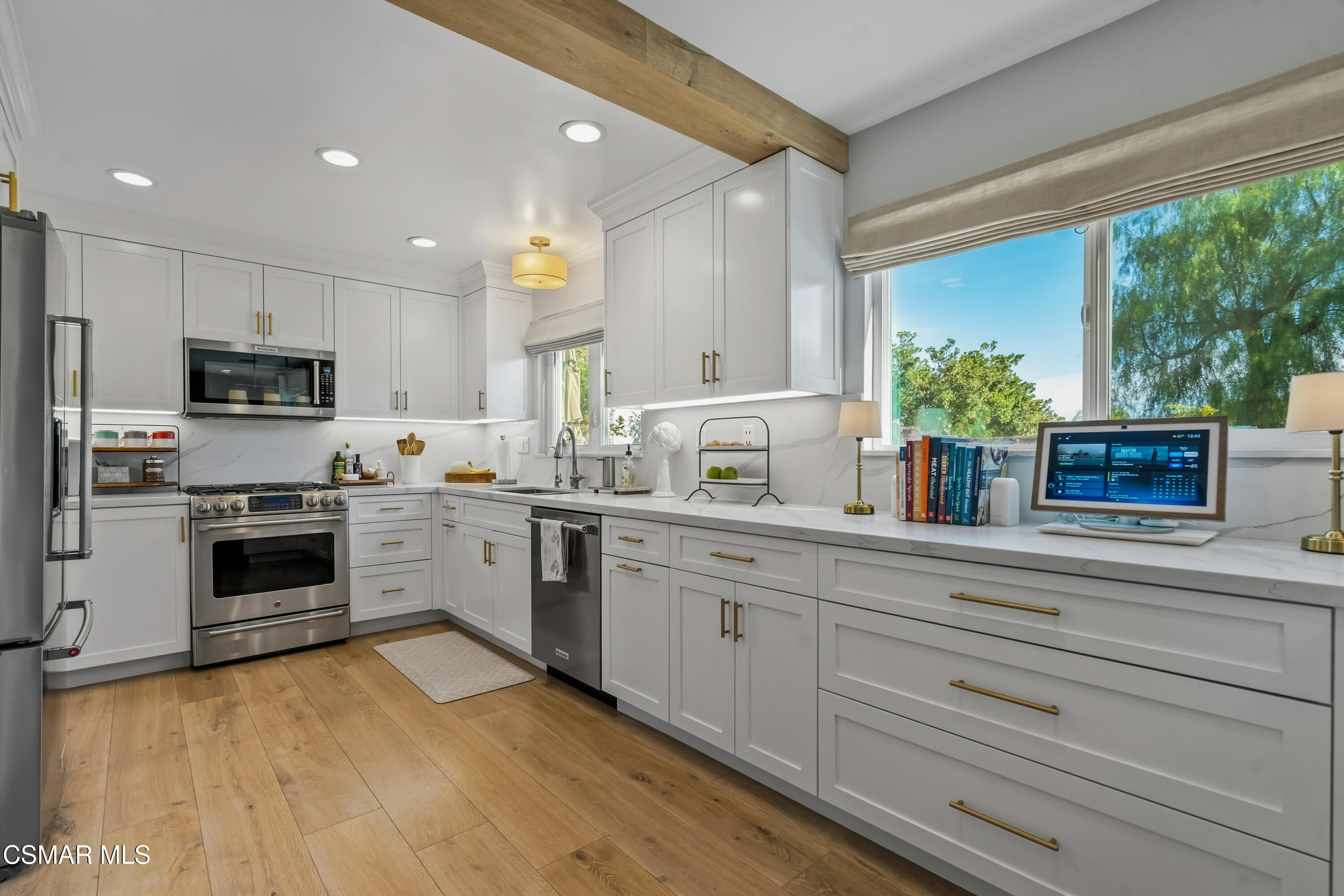 584 Fresh Meadows Road Simi Valley, CA 93065 - Photo 11 of 29 a kitchen with a sink cabinets stainless steel appliances and a large window