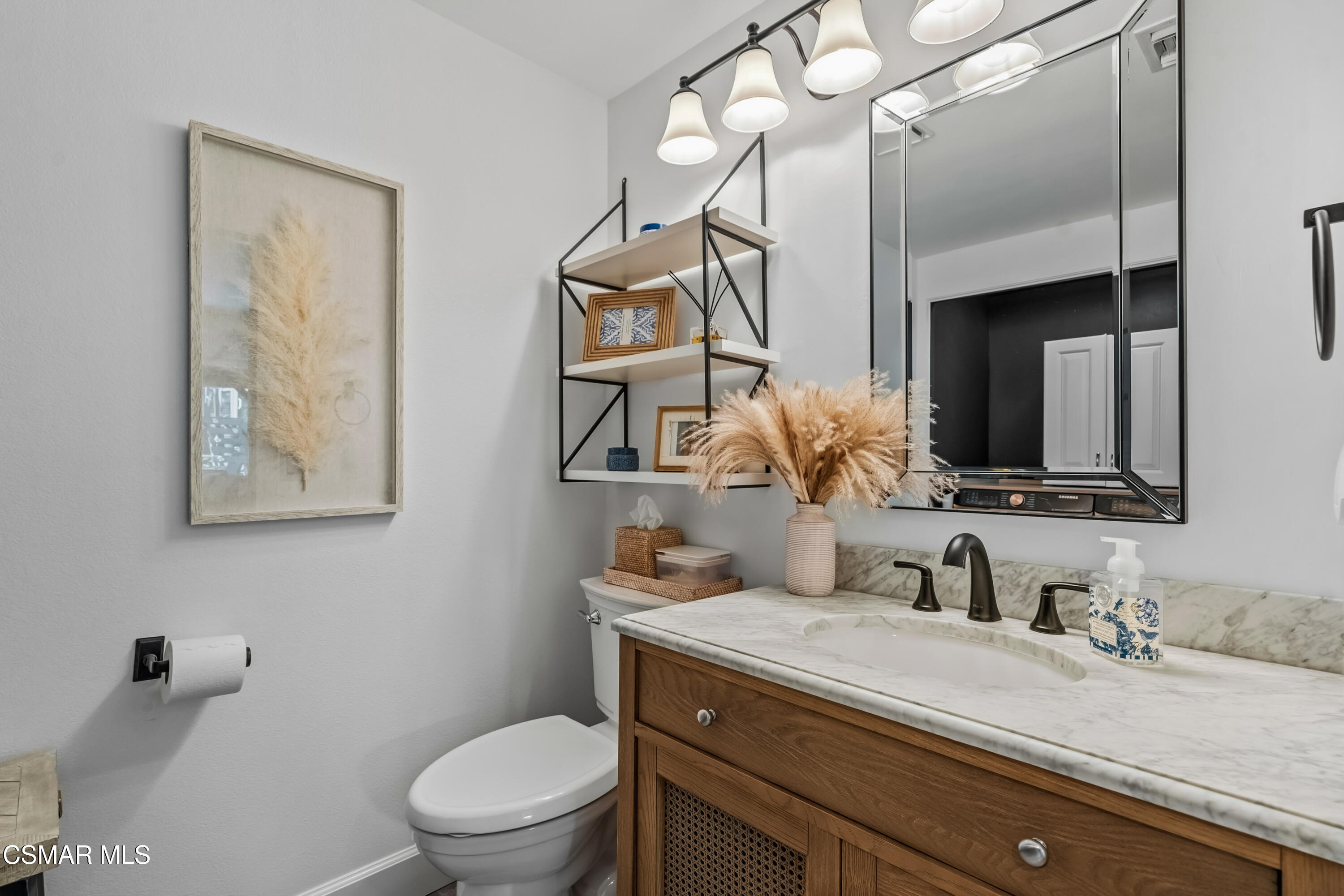584 Fresh Meadows Road Simi Valley, CA 93065 - Photo 18 of 29 a bathroom with a granite countertop sink a toilet and mirror