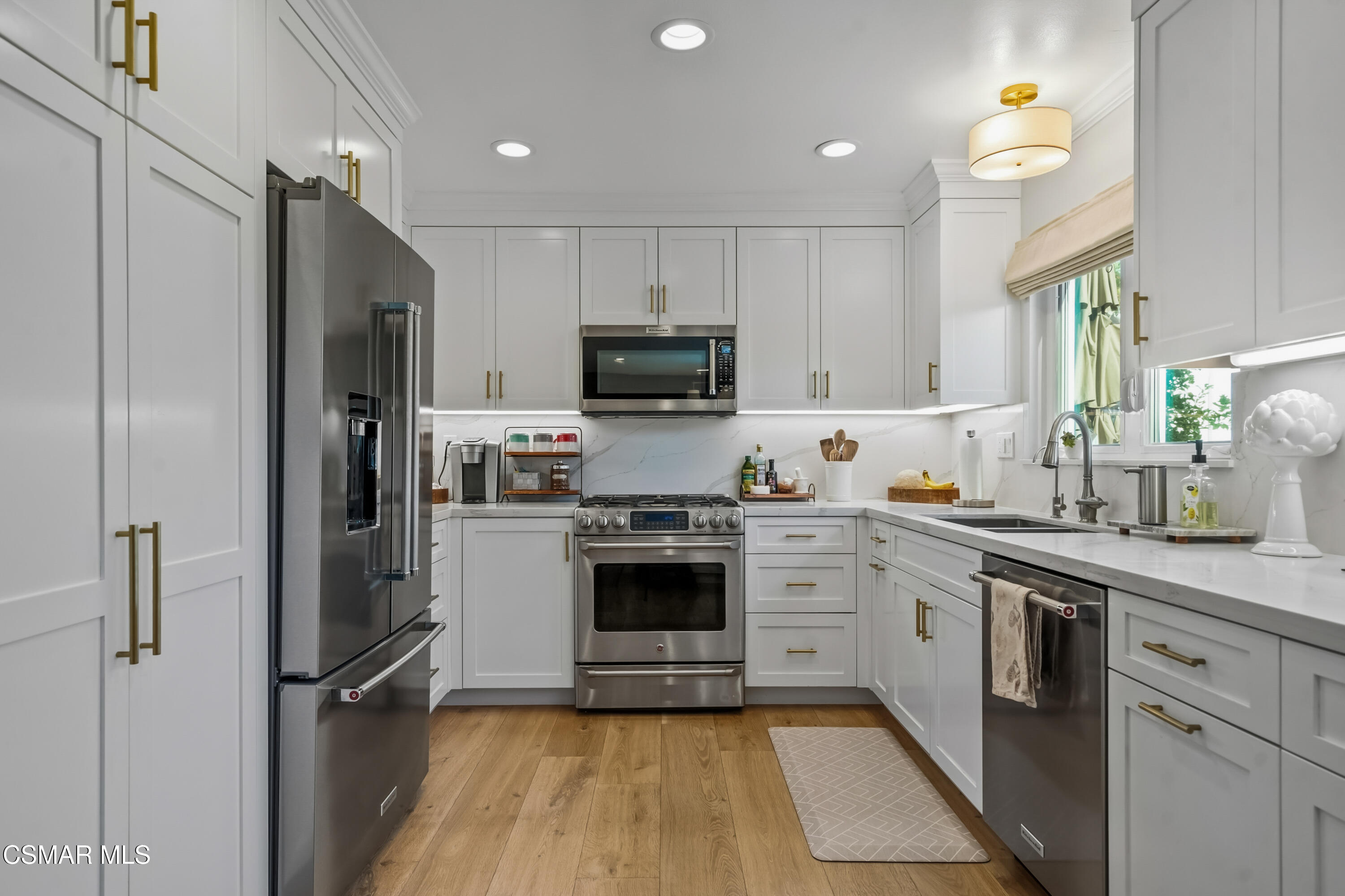 584 Fresh Meadows Road Simi Valley, CA 93065 - Photo 8 of 29 a kitchen with cabinets and stainless steel appliances