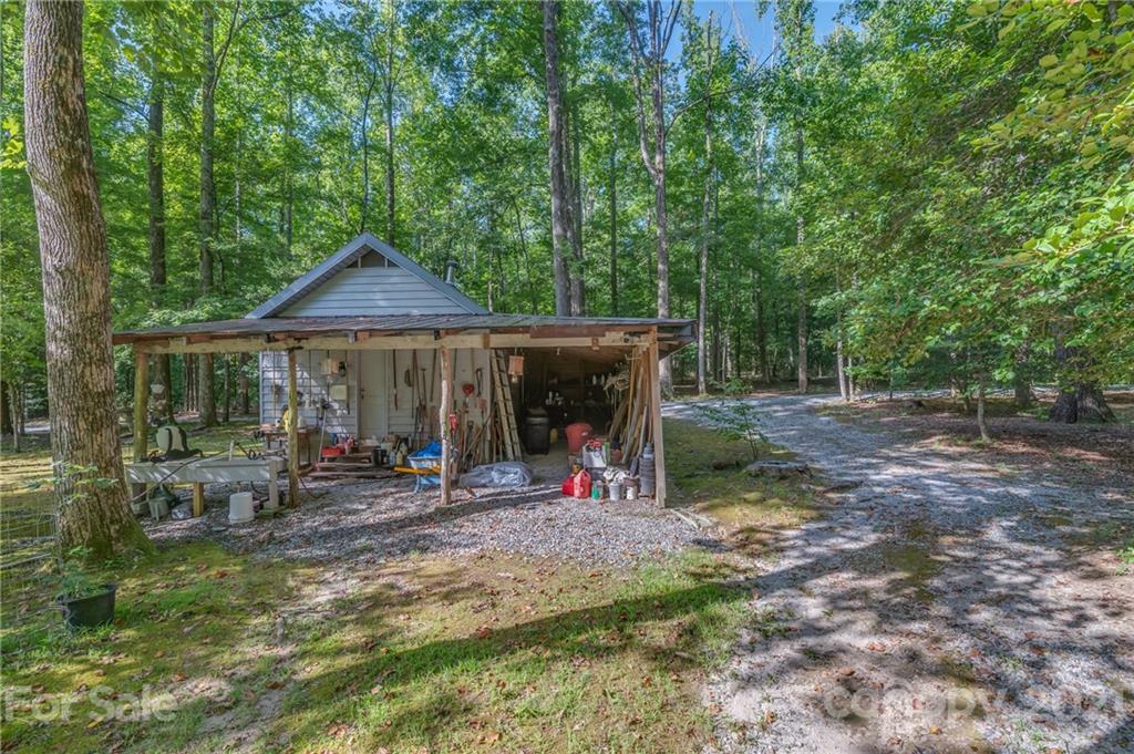 127 Pink Campbell Road, Unit 3B Landrum, SC 29356 - Photo 44 of 46 a view of a chair and table in the backyard