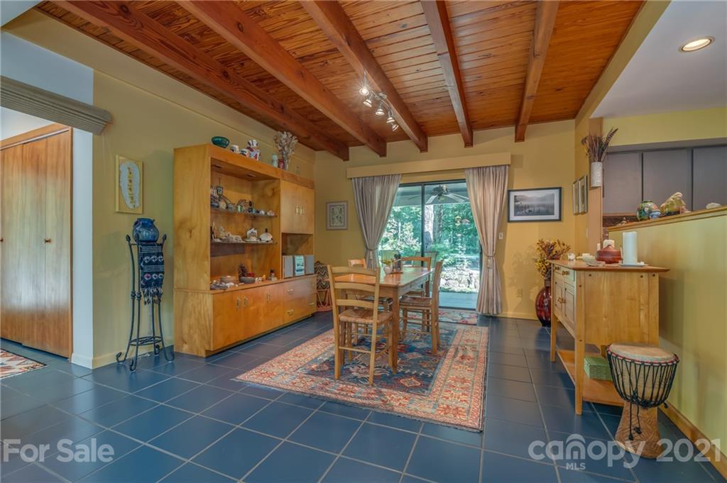 127 Pink Campbell Road, Unit 3B Landrum, SC 29356 - Photo 8 of 46 a dining room with furniture and a floor to ceiling window