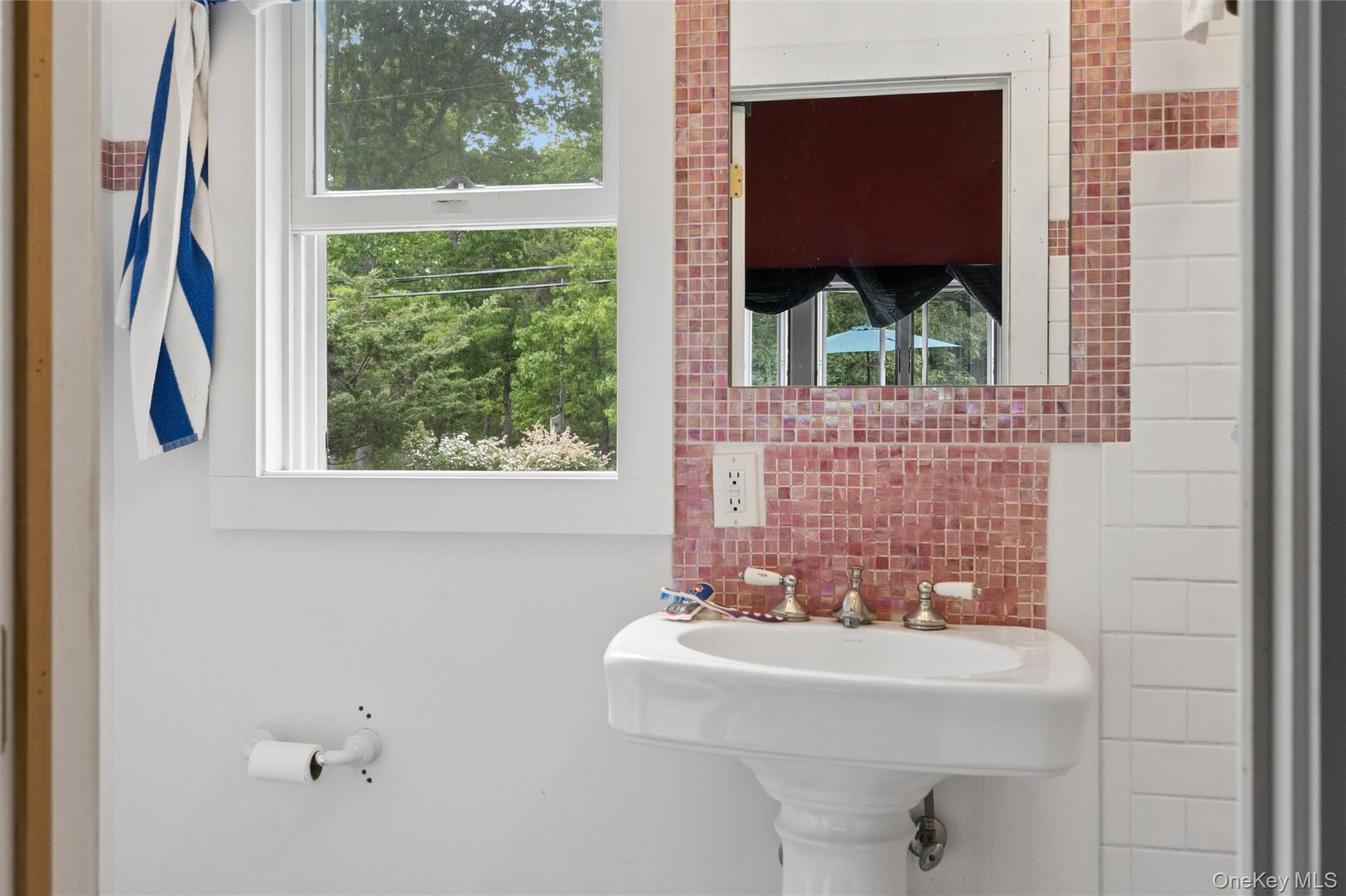 131 Red Creek Road Hampton Bays, NY 11946 - Photo 18 of 35 a bathroom with a sink and a large window