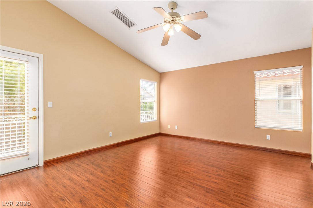 1477 Rancho Ridge Drive Henderson, NV 89012 - Photo 17 of 46 Hardwood floors and vaulted ceilings elevate this airy, versatile room.