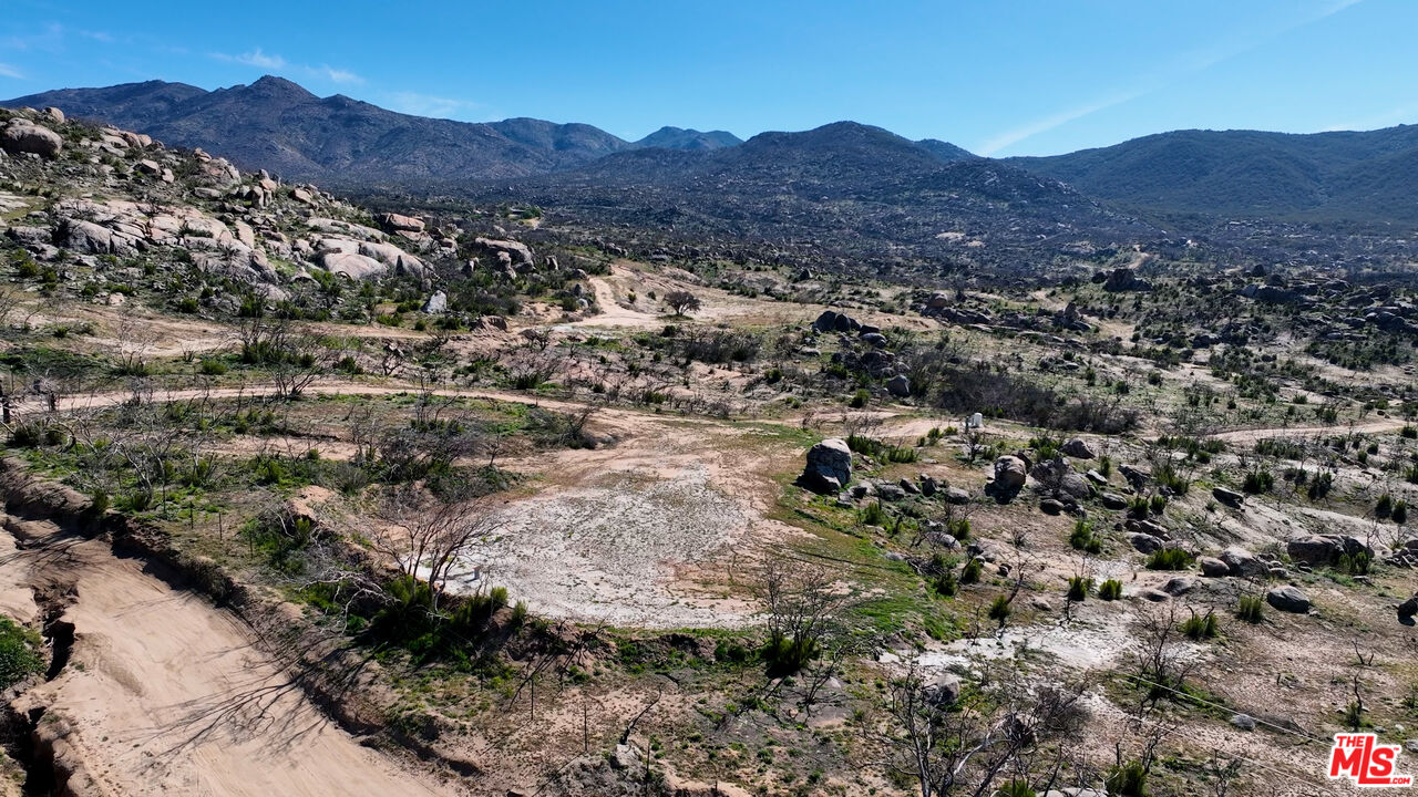 51919 Tule Peak Road Aguanga, CA 92536 - Photo 15 of 44 a view of a lush green hillside and houses