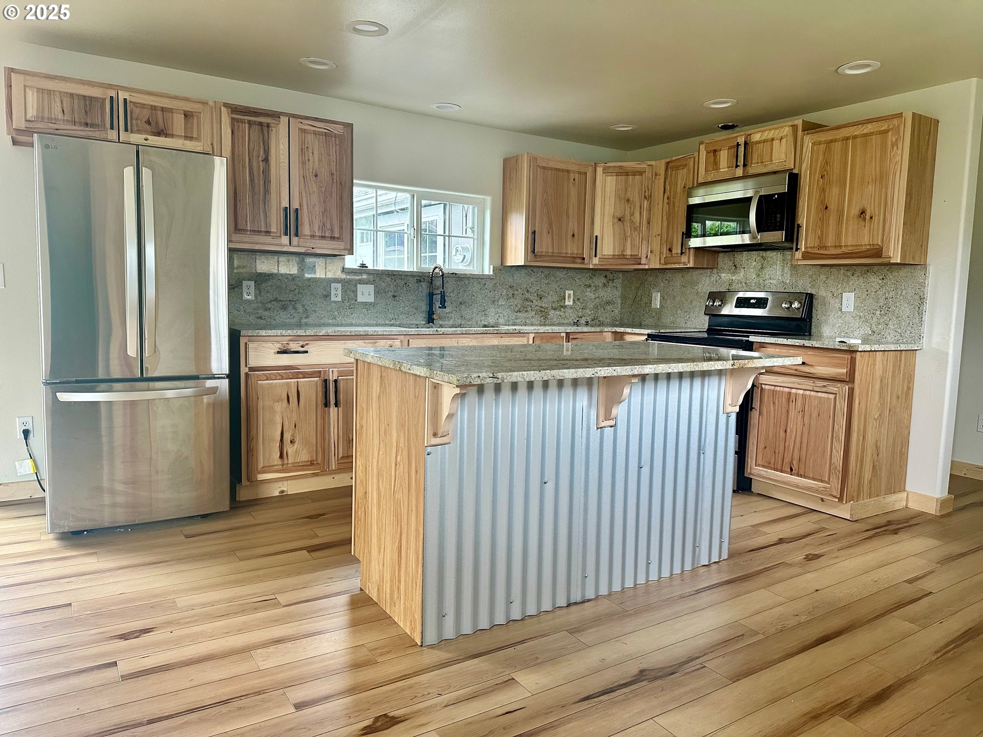 765 State Street North Bend, OR 97459 - Photo 39 of 46 a kitchen with stainless steel appliances granite countertop a stove top oven a refrigerator and cabinets