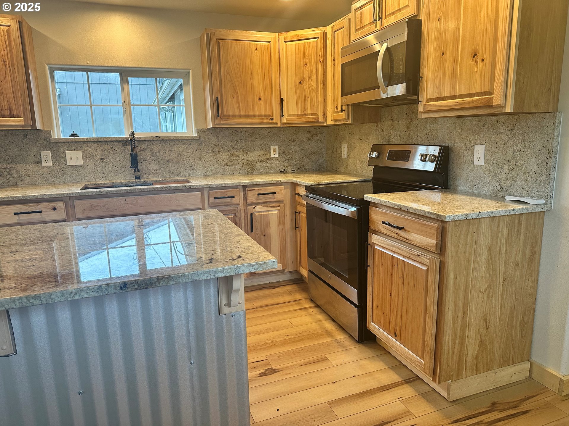 765 State Street North Bend, OR 97459 - Photo 42 of 46 a kitchen with stainless steel appliances granite countertop a sink stove and cabinets