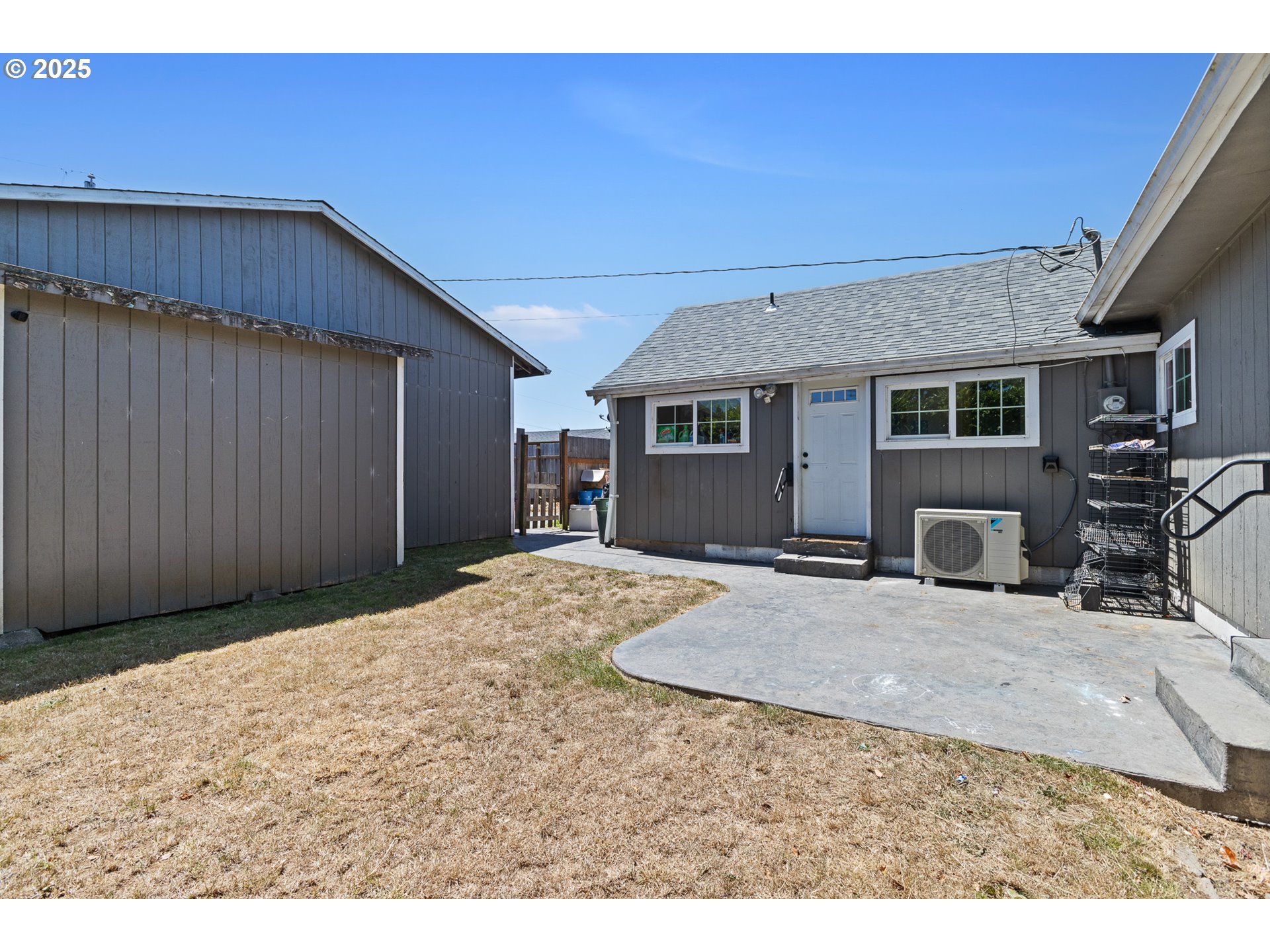 765 State Street North Bend, OR 97459 - Photo 6 of 46 a view of a bedroom with a flat screen tv with wooden floor