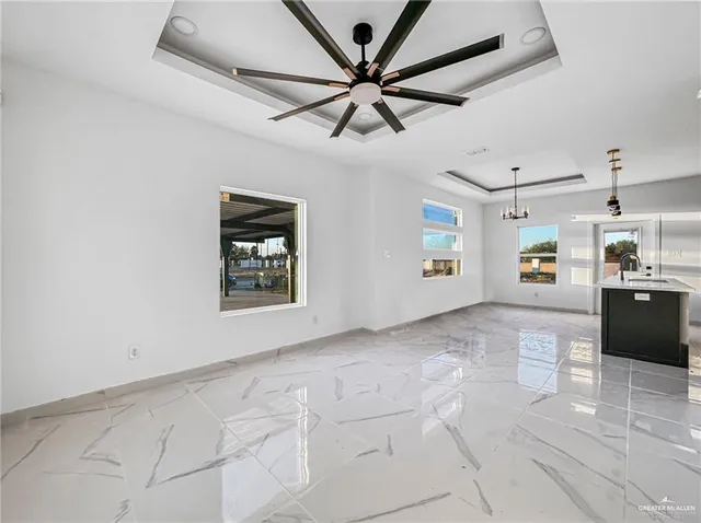 a view of a hallway with a window and a ceiling fan