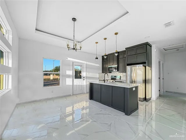 a kitchen with refrigerator and cabinets