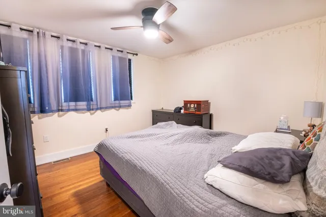 a bedroom with bed and wooden floor