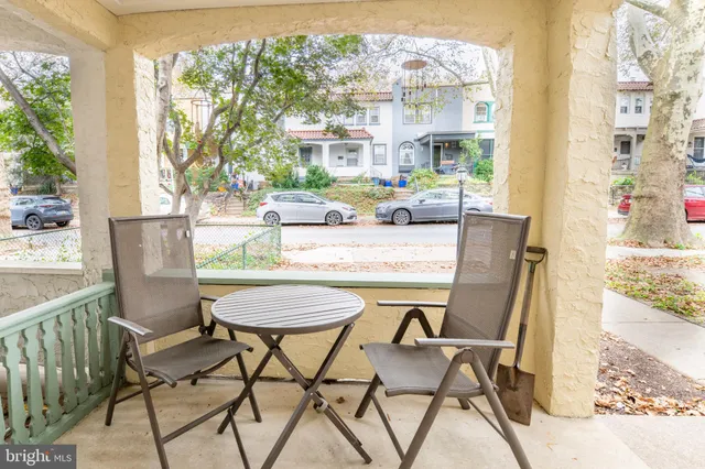 a dining room with furniture and a floor to ceiling window