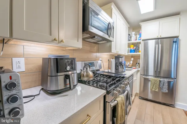 a kitchen with a refrigerator and a stove