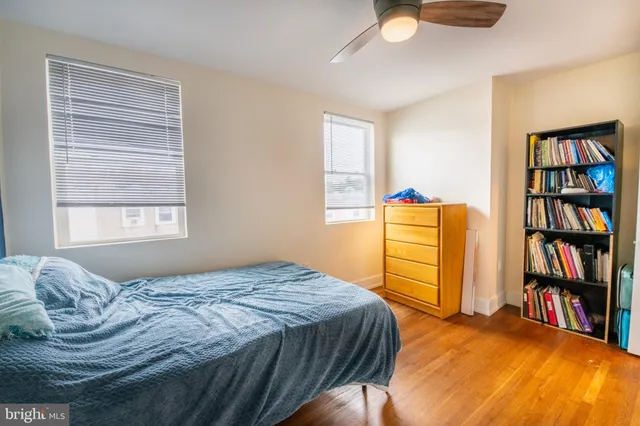 a bedroom with a bed and a book shelf