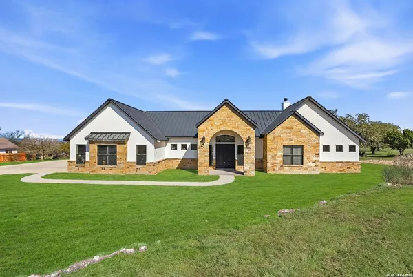a view of house with yard and green space