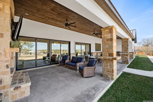 a view of a patio with couches table and chairs and potted plants