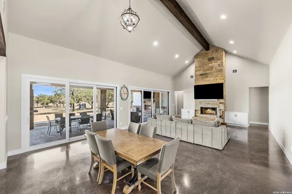 a living room with furniture a flat screen tv and a large window