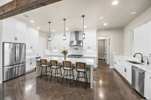 a large kitchen with a table and chairs