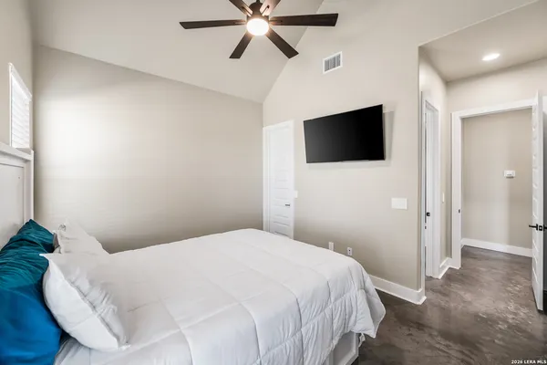 a bedroom with a bed and a flat screen tv