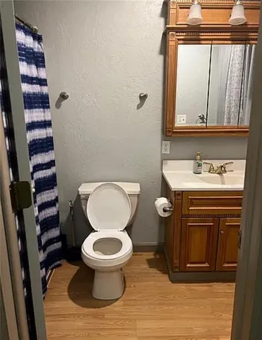 a bathroom with a toilet a sink and a mirror