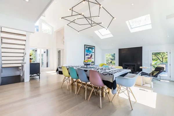 a kitchen with stainless steel appliances granite countertop a stove a sink a refrigerator and a fireplace