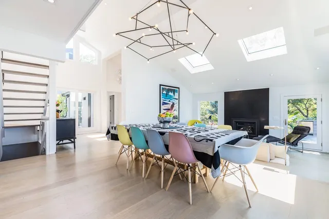 a kitchen with stainless steel appliances granite countertop a stove a sink a refrigerator and a fireplace