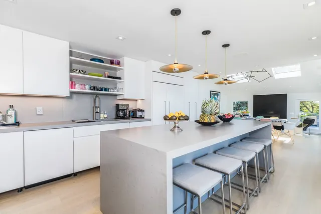 a spacious bathroom with a tub sink and mirror