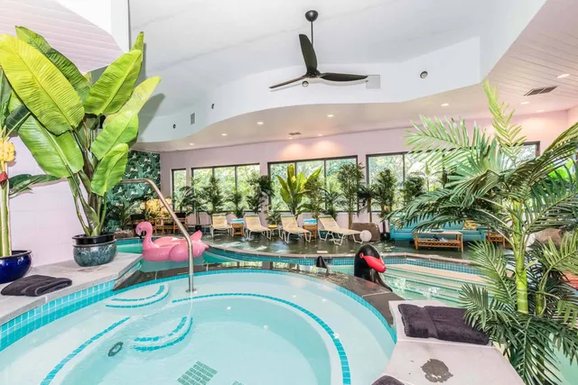 a swimming pool view with a sitting space