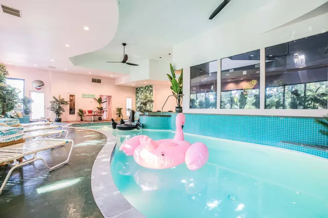 a view of a patio with couches chairs and wooden floor