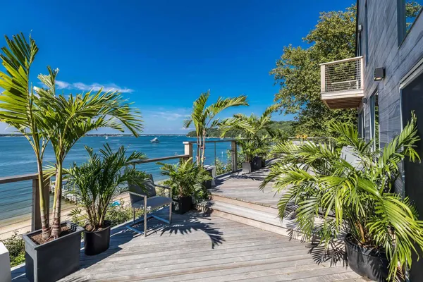 a terrace with chairs and wooden floor