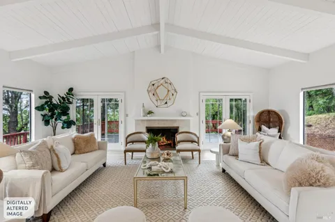 a living room with furniture a fireplace and a large window