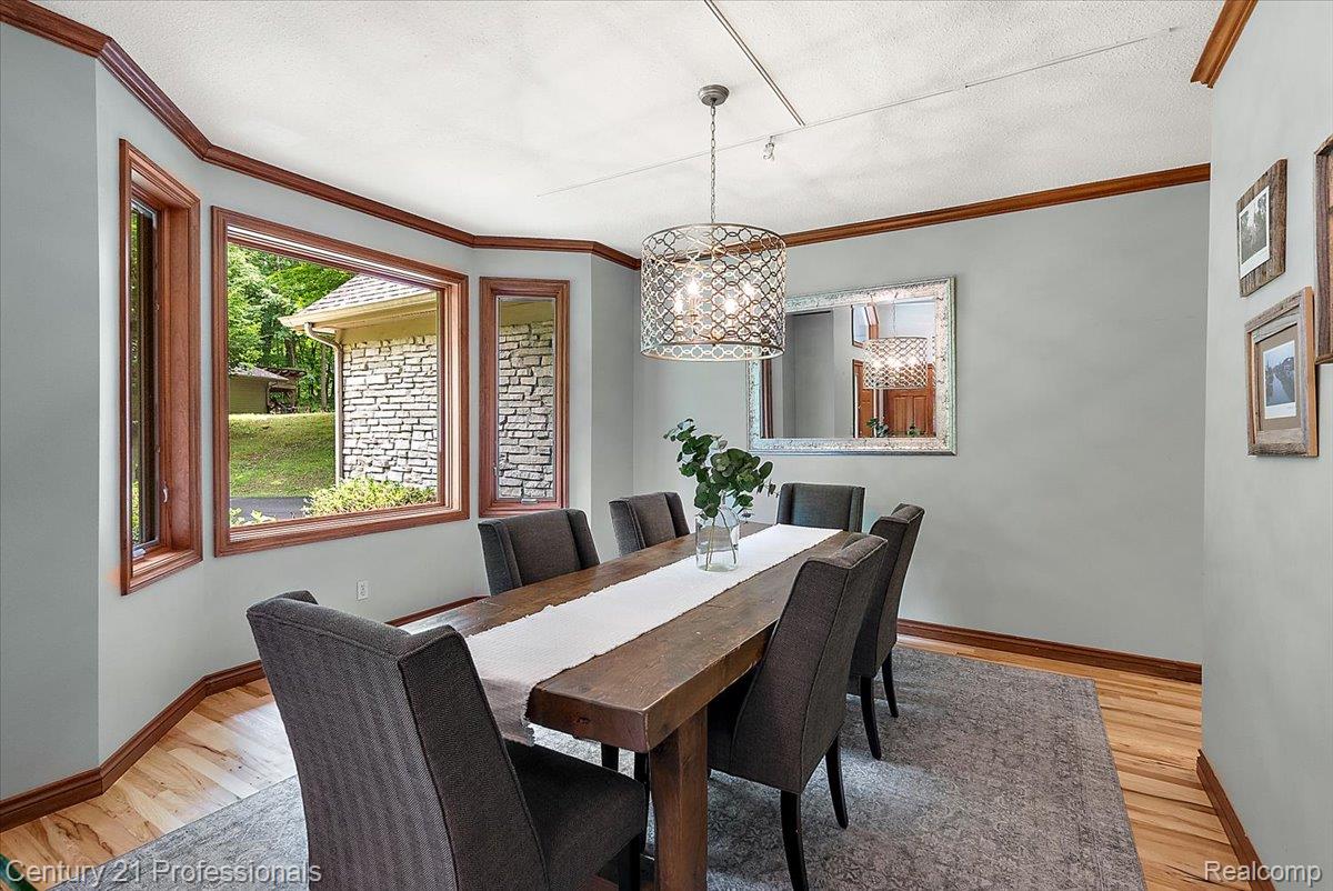 9867 Rainbow Ridge Drive Schoolcraft, MI 49087 - Photo 28 of 82 Dining area featuring a prominent bay window with wood trim and light-toned walls
