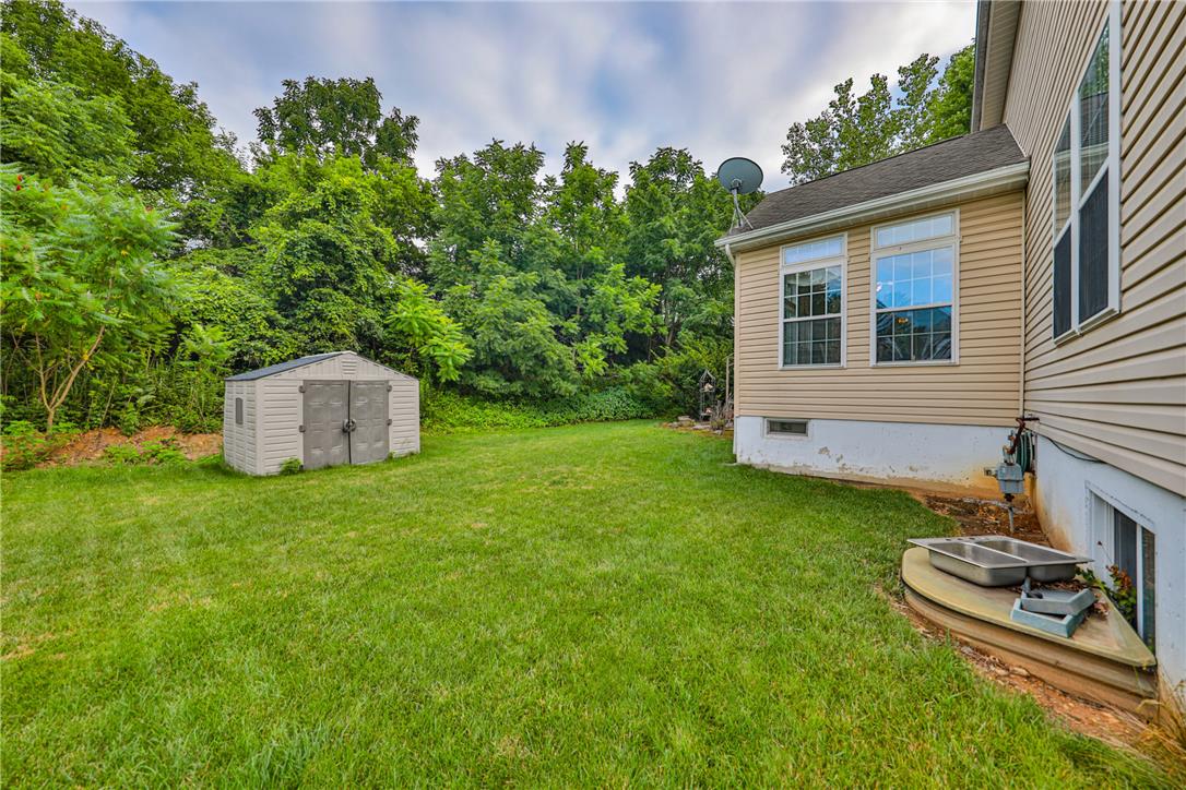138 Clover Hollow Road Easton, PA 18045 - Photo 76 of 95 A generous backyard offers lush green space and practical outdoor storage.