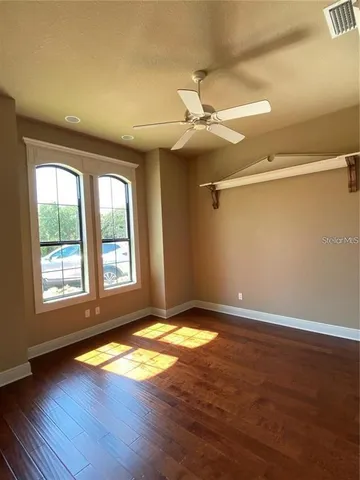a view of an empty room with a fireplace and a window