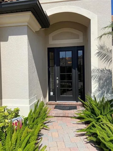 a view of a hallway with a chandelier and livingroom