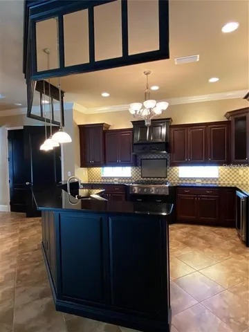 a stove top oven sitting inside of a kitchen