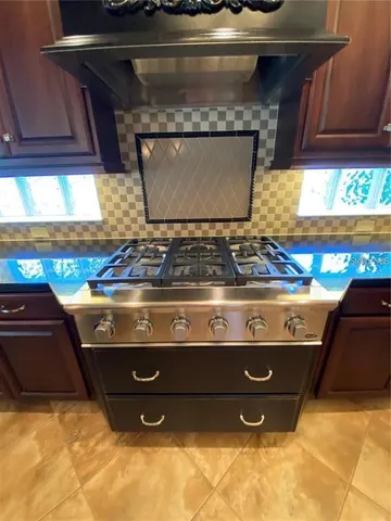 a kitchen with kitchen island granite countertop a sink counter top space appliances and cabinets