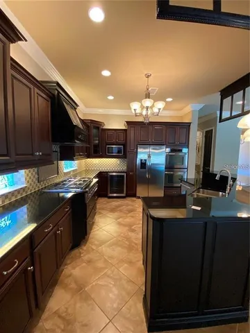 a kitchen with granite countertop a refrigerator and a stove