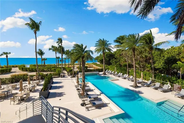 a living room with furniture and large windows