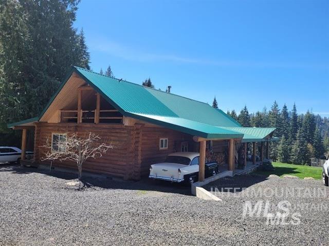 112 Three Forks Road Kamiah, ID 83536 - Photo 45 of 45 View of home's exterior featuring log siding, a metal roof, gravel driveway, and an attached carport
