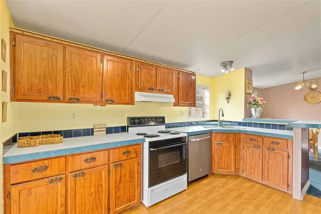 a kitchen with stainless steel appliances granite countertop a stove sink and cabinets