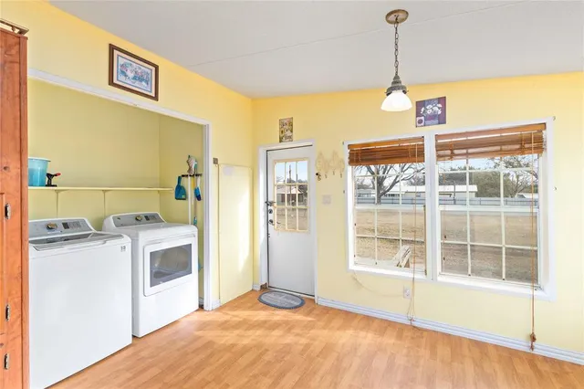a view of a kitchen with a stove fridge and wooden floor