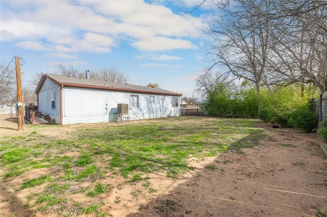 a front view of house with yard and trees