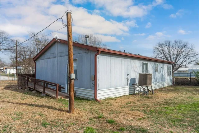 a backyard of a house with table and chairs