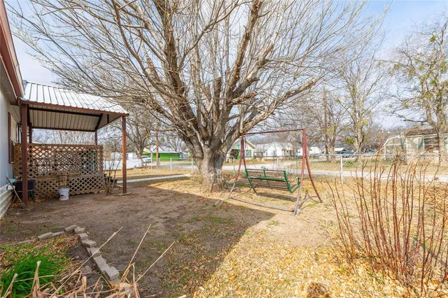 a view of a yard with snow on the road
