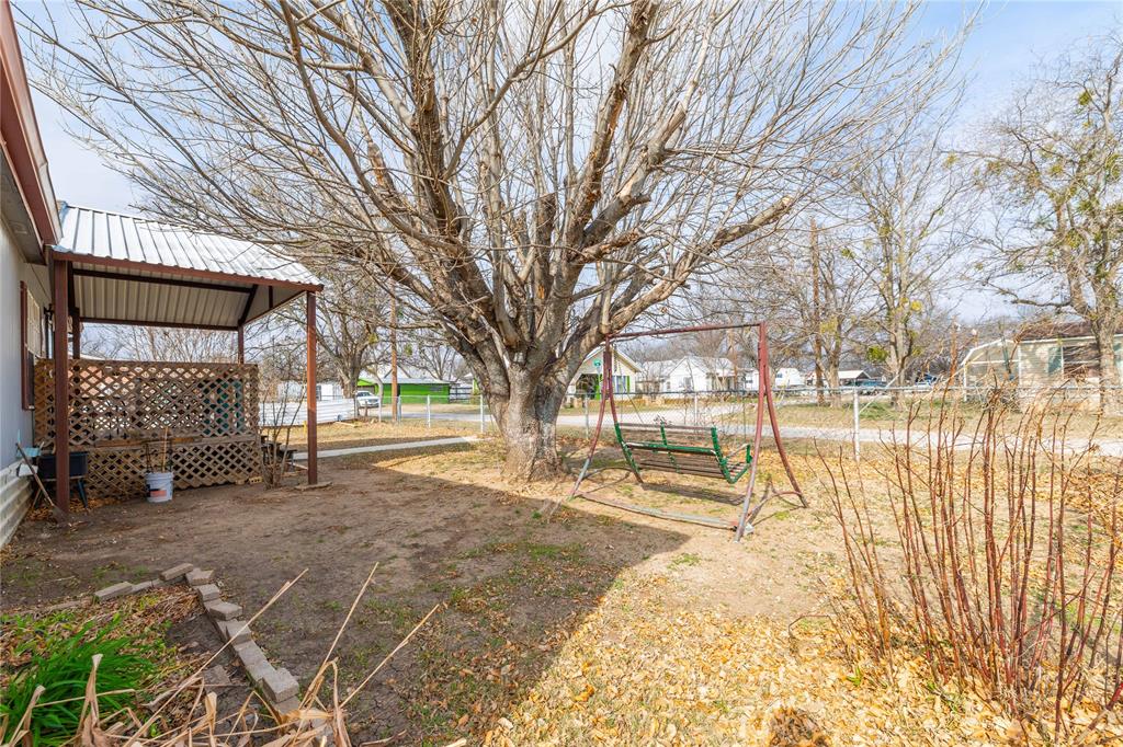 209 Martin Street Bangs, TX 76823 - Photo 27 of 31 Front yard is fenced with a covered front porch