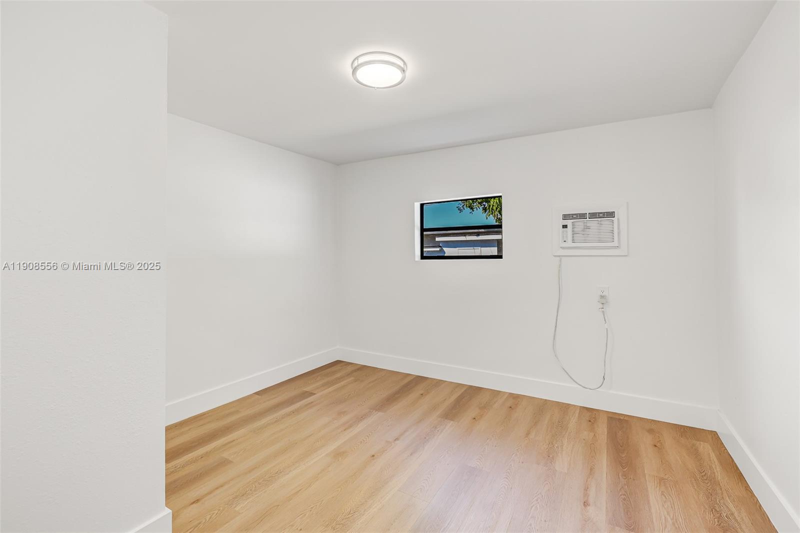 Grapeland Heights Estates Miami, FL 33125 - Photo 18 of 26 a view of a room with wooden floor and white walls